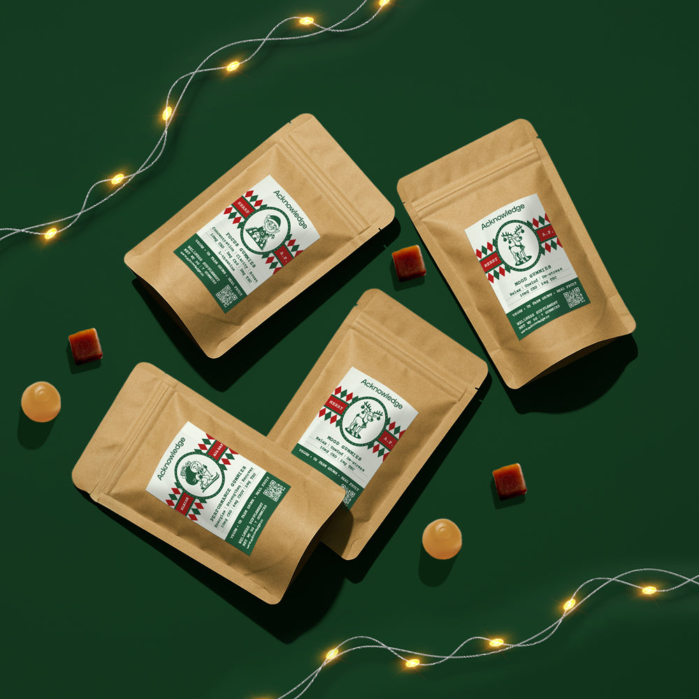 Acknowledge holiday edition CBD gummies in kraft packaging and string lights, promoting seasonal wellness gifts.
