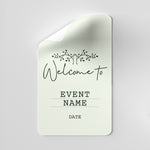 White card with 'Welcome to Event Name Date' text on a gray background