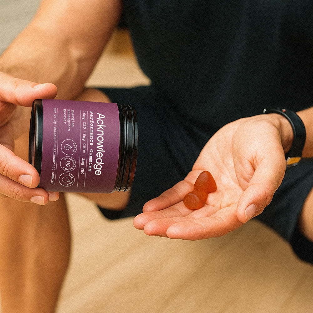 Person holding Acknowledge Performance Gummies made with full-spectrum CBD and CBDV for natural energy and recovery.