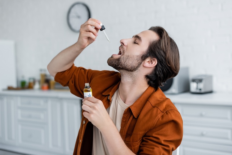 a man tasting sour suver haze cbd oil